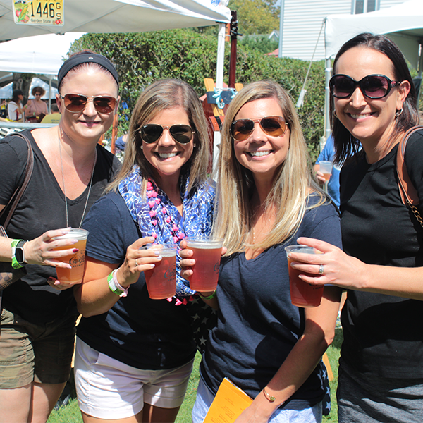 four women holding beer at the cape may mac harvest brew fest