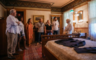 victorian dressed tour guide giving a tour in the emlen physick estate bedroom